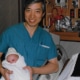 Dr. Man Fan Ho holding a newborn baby
