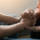 A doctor holding a patient's hands