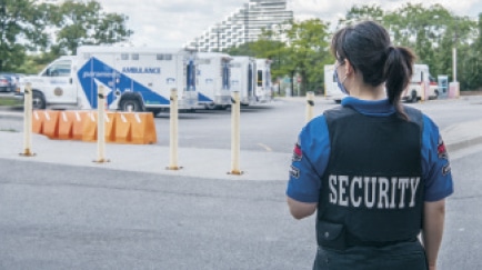 Malissa notifies security. They will need to hold other patients from coming through to alleviate congestion and ensure there is an unobstructed path when the ambulance pulls up.